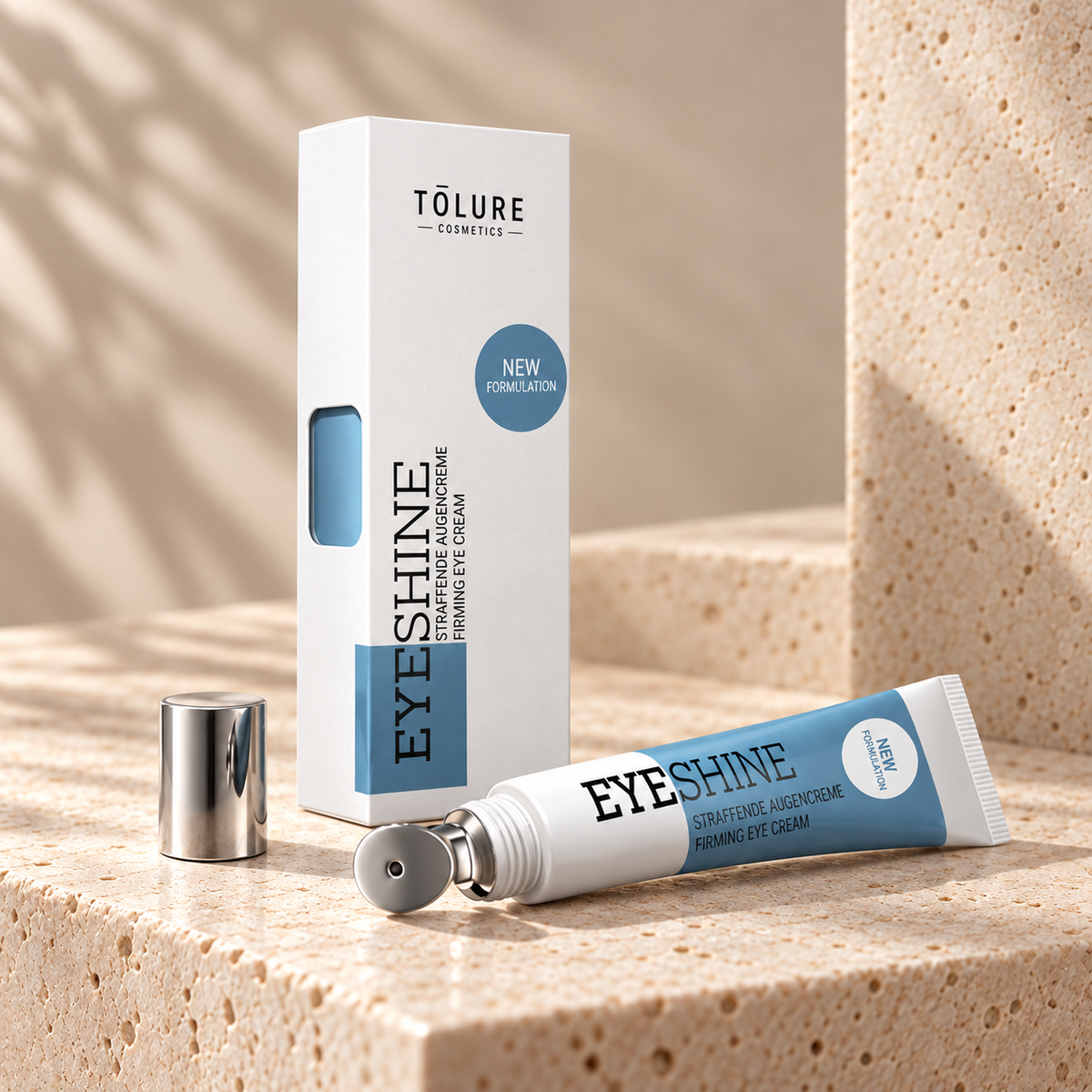 Tolure Eyeshine øjencreme på travertin i samme beige billedstil.
