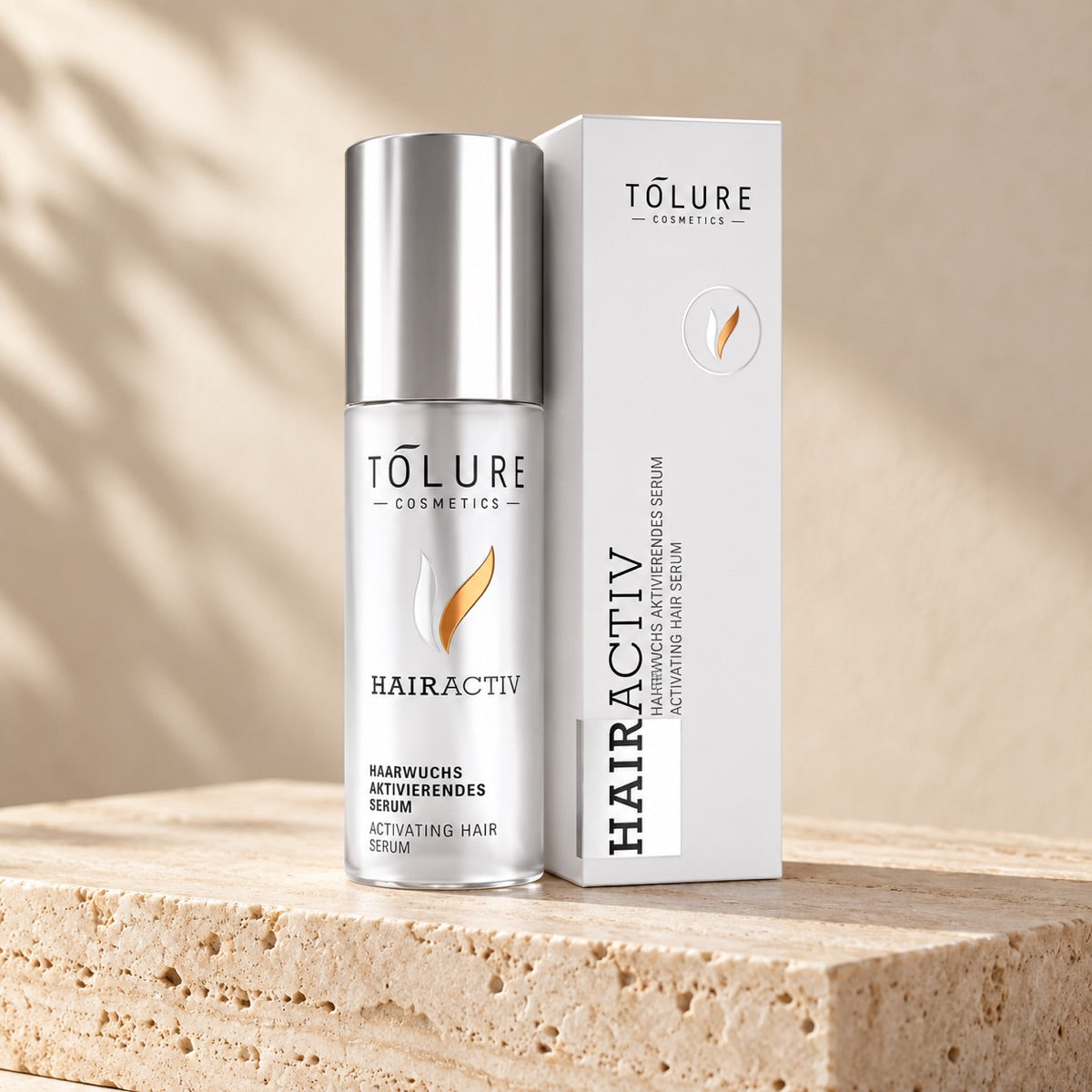 Tolure HairActiv hovedbundsserum 100 ml med sølvfarvet flaske og æske på travertin.