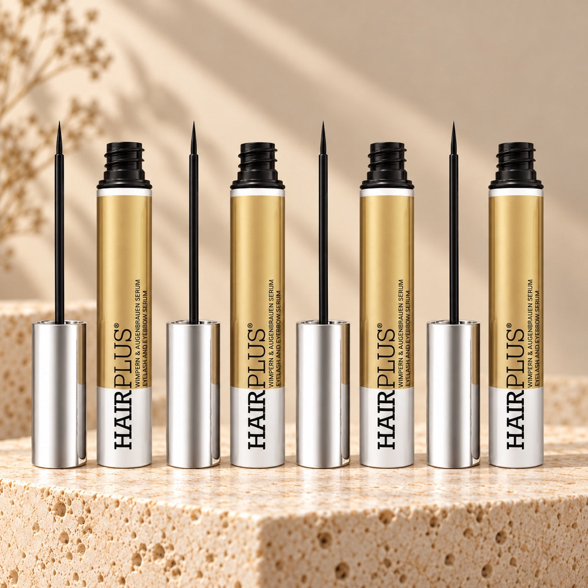 Tolure Hairplus 4-pack med fire serumflasker à 3 ml og pensler på travertin.